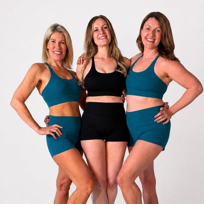 Three women modeling the 'Emma' Sports Bra in various colors, showcasing style and comfort for workouts.