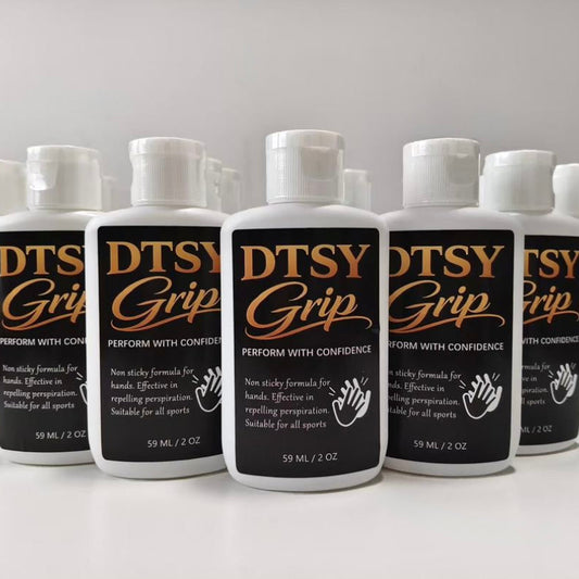 Multiple bottles of DTSY Grip on a white surface with a gray background