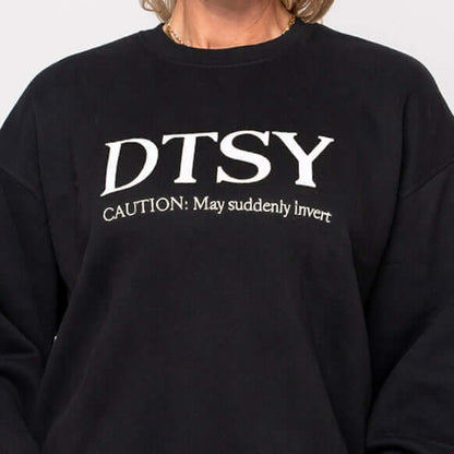 Aerialist Jumper featuring the text 'DTSY Caution: May suddenly invert' in soft black fabric.